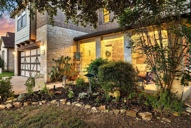 1149 Hyde Park Dr, Round Rock, TX 78665 - view of front facade featuring stone siding, an attached garage, driveway, and brick siding