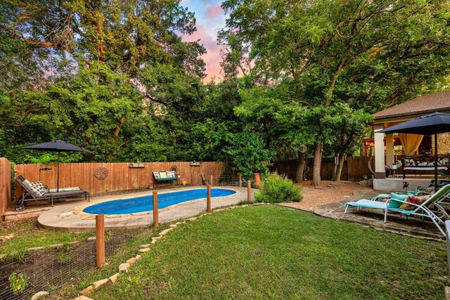 1149 Hyde Park Dr, Round Rock, TX 78665 - pool at dusk with a gazebo, a fenced backyard, and a patio
