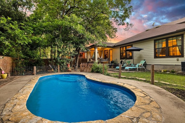1149 Hyde Park Dr, Round Rock, TX 78665 - pool at dusk with a patio and a fenced backyard