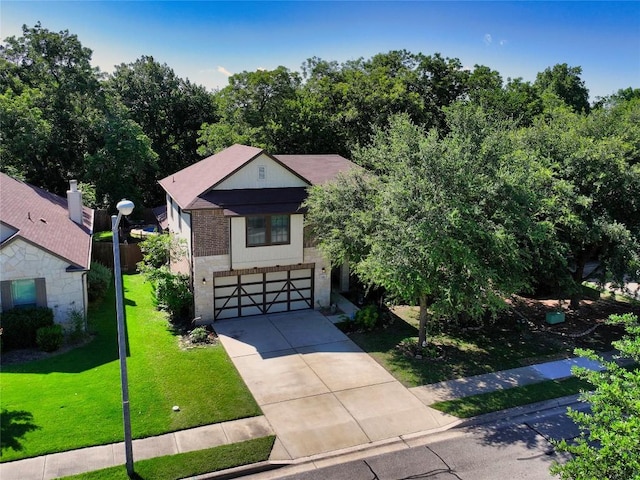 1149 Hyde Park Dr, Round Rock, TX 78665 - view of front of house with a garage, concrete driveway, a front yard, and brick siding