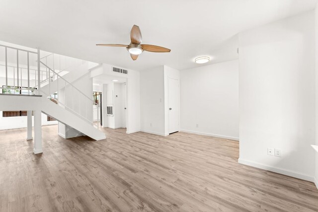 903 Silver Quail Ln, Austin, TX 78758 - unfurnished living room with wood finished floors, stairs, and ceiling fan