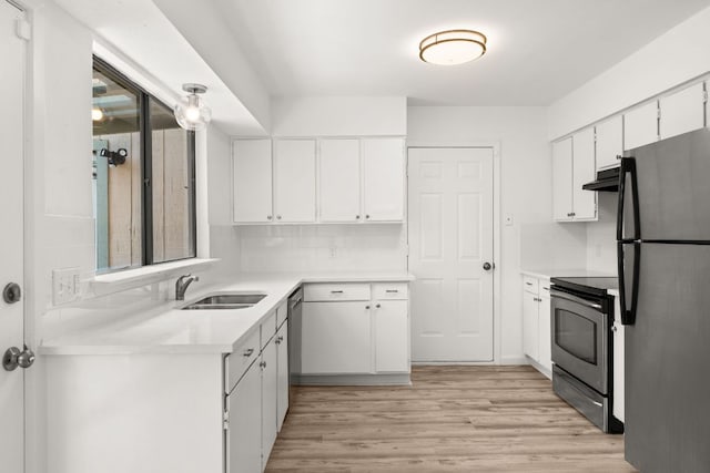 903 Silver Quail Ln, Austin, TX 78758 - kitchen with stainless steel appliances, under cabinet range hood, white cabinetry, light countertops, and light wood-type flooring