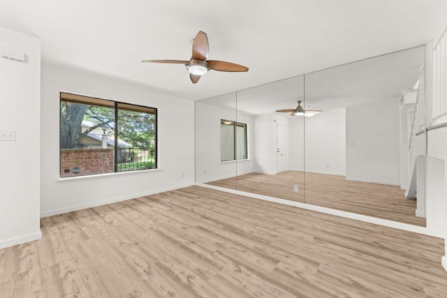 903 Silver Quail Ln, Austin, TX 78758 - unfurnished living room with a ceiling fan and light wood-style floors