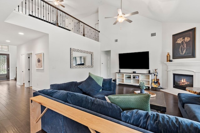 841 Expedition Way, Round Rock, TX 78665 - living area featuring a ceiling fan, wood finished floors, high vaulted ceiling, a glass covered fireplace, and recessed lighting
