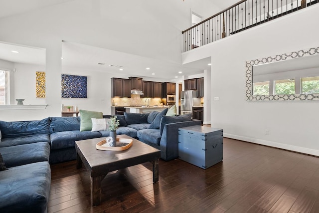 841 Expedition Way, Round Rock, TX 78665 - living room with dark wood-style flooring, plenty of natural light, a towering ceiling, and recessed lighting