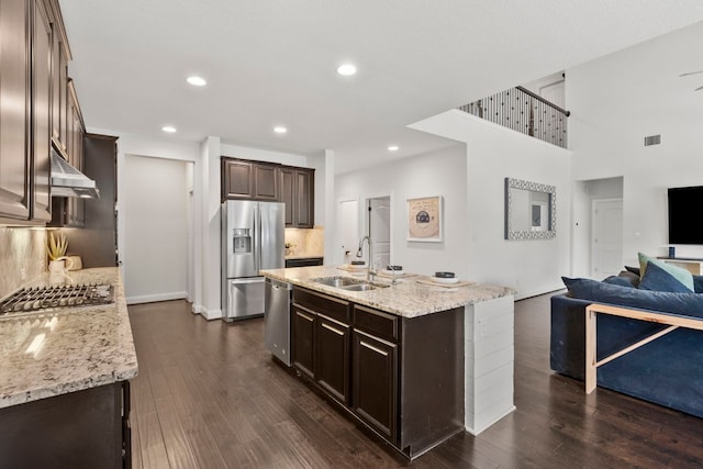 841 Expedition Way, Round Rock, TX 78665 - kitchen featuring appliances with stainless steel finishes, open floor plan, dark brown cabinetry, dark wood finished floors, and recessed lighting