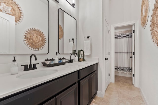841 Expedition Way, Round Rock, TX 78665 - bathroom featuring double vanity and baseboards