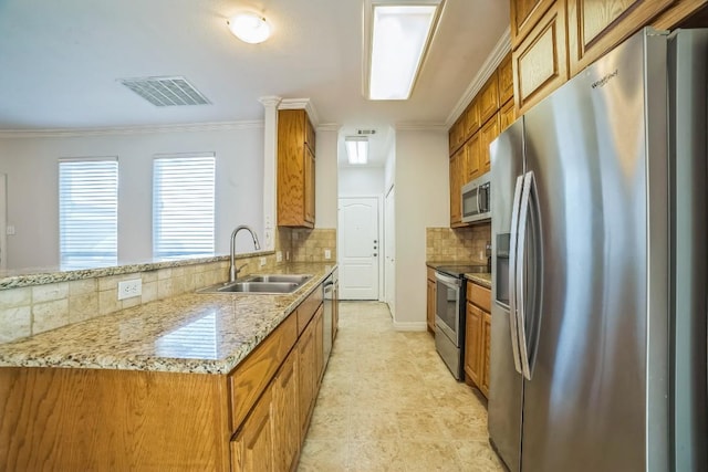 1213 Delsie Dr Unit A, Austin, TX 78734 - kitchen featuring appliances with stainless steel finishes, brown cabinets, decorative backsplash, crown molding, and a peninsula