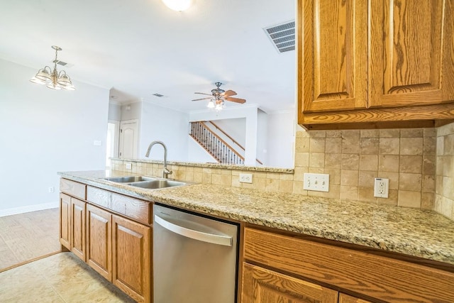 1213 Delsie Dr Unit A, Austin, TX 78734 - kitchen with stainless steel dishwasher, light stone countertops, ornamental molding, brown cabinets, and backsplash