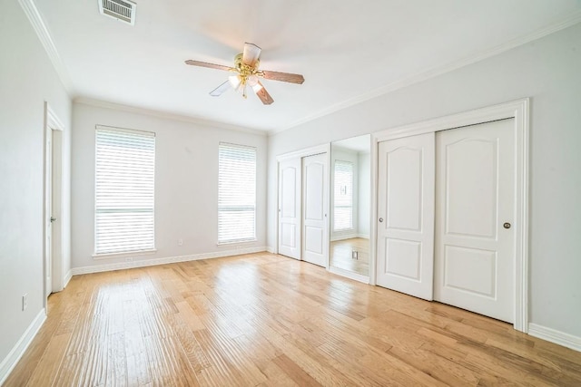 1213 Delsie Dr Unit A, Austin, TX 78734 - unfurnished bedroom featuring ornamental molding, multiple closets, light wood-style flooring, and ceiling fan