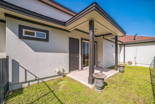 1213 Delsie Dr Unit A, Austin, TX 78734 - back of house featuring stucco siding, a yard, and a patio