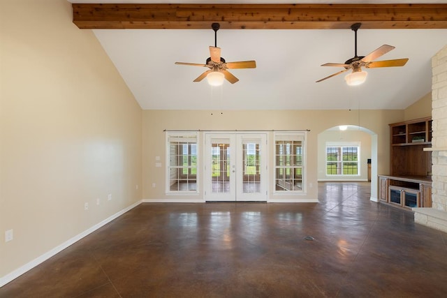 10565 N 77th Hwy, Lexington, TX 78947 - unfurnished living room featuring ceiling fan, french doors, beamed ceiling, high vaulted ceiling, and arched walkways