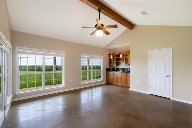 10565 N 77th Hwy, Lexington, TX 78947 - unfurnished living room featuring beamed ceiling, a ceiling fan, dark tile patterned floors, and high vaulted ceiling