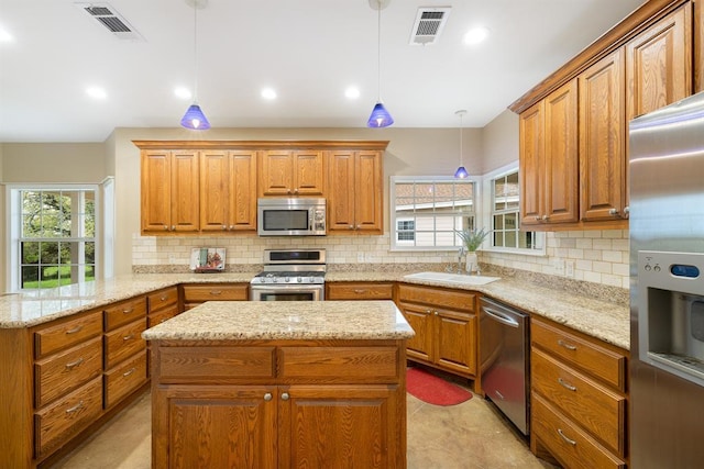 10565 N 77th Hwy, Lexington, TX 78947 - kitchen featuring appliances with stainless steel finishes, tasteful backsplash, brown cabinets, and recessed lighting