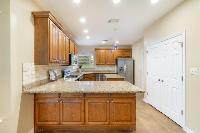 10565 N 77th Hwy, Lexington, TX 78947 - kitchen with stainless steel appliances, brown cabinets, tasteful backsplash, a peninsula, and recessed lighting
