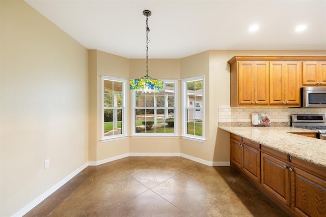 10565 N 77th Hwy, Lexington, TX 78947 - kitchen with appliances with stainless steel finishes, backsplash, finished concrete flooring, decorative light fixtures, and light stone counters