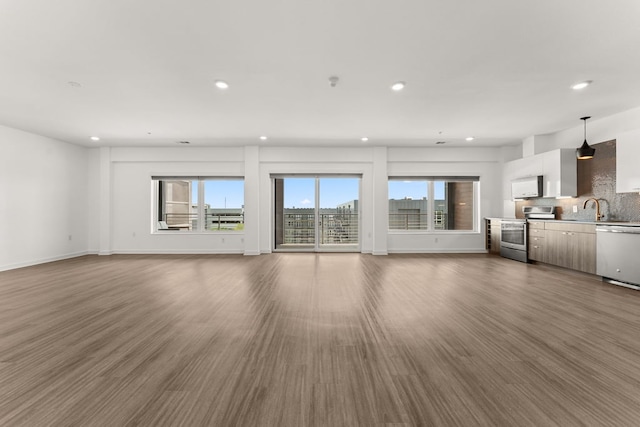 4361 S Congress Ave Unit 514, Austin, TX 78745 - unfurnished living room with plenty of natural light, recessed lighting, and wood finished floors