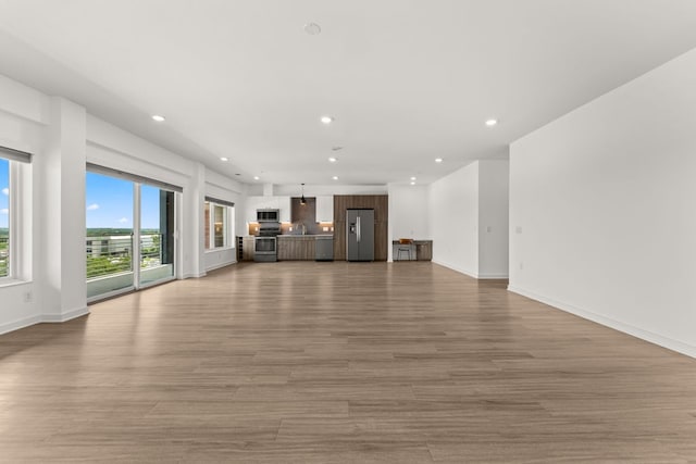 4361 S Congress Ave Unit 514, Austin, TX 78745 - unfurnished living room featuring recessed lighting and light wood-style floors