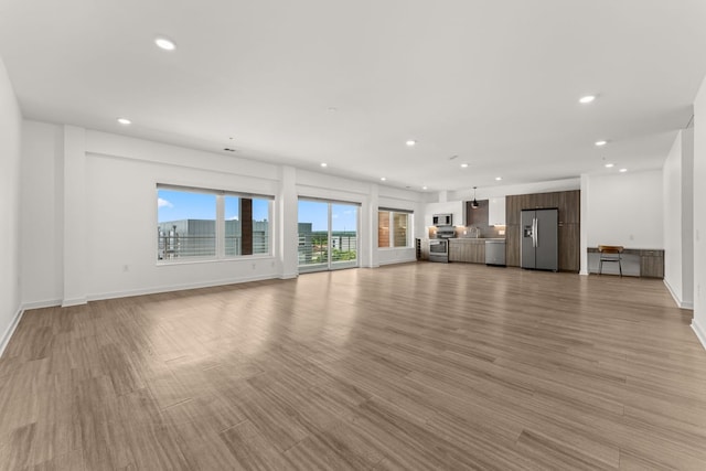4361 S Congress Ave Unit 514, Austin, TX 78745 - unfurnished living room with recessed lighting and light wood finished floors
