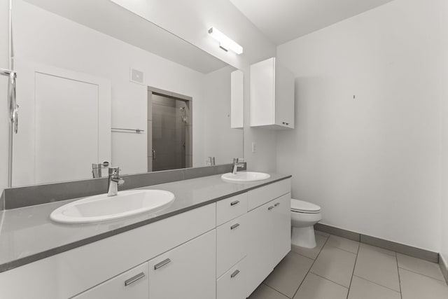 4361 S Congress Ave Unit 514, Austin, TX 78745 - bathroom with double vanity, a shower stall, and tile patterned floors
