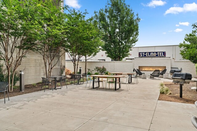 4361 S Congress Ave Unit 514, Austin, TX 78745 - view of home's community featuring a fire pit, a patio area, and outdoor dining area