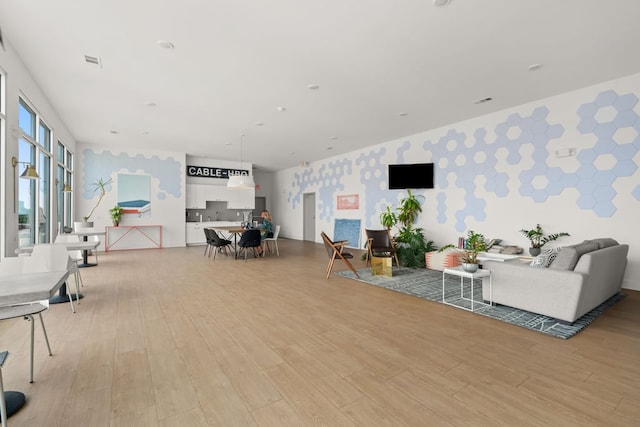 4361 S Congress Ave Unit 514, Austin, TX 78745 - living area featuring wallpapered walls and light wood-style flooring