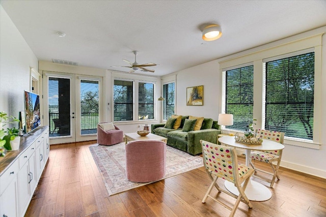 6608 Lantern View Dr Unit 102, Jonestown, TX 78645 - living area featuring healthy amount of natural light, ceiling fan, and hardwood / wood-style flooring