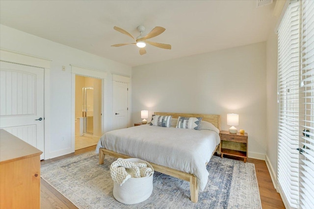 6608 Lantern View Dr Unit 102, Jonestown, TX 78645 - bedroom with wood finished floors, connected bathroom, and a ceiling fan