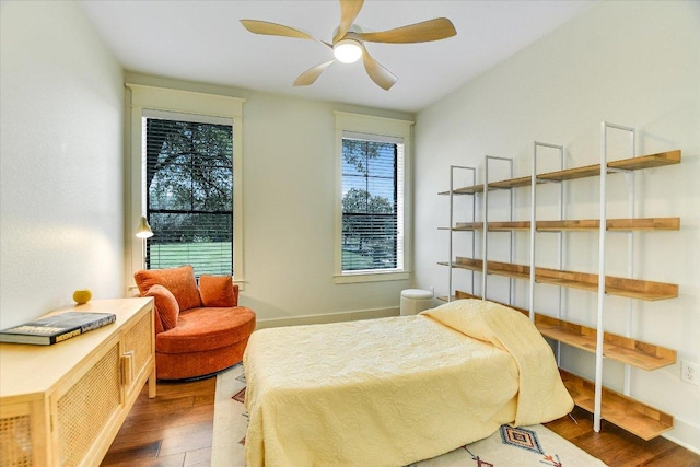 6608 Lantern View Dr Unit 102, Jonestown, TX 78645 - bedroom with wood finished floors and a ceiling fan