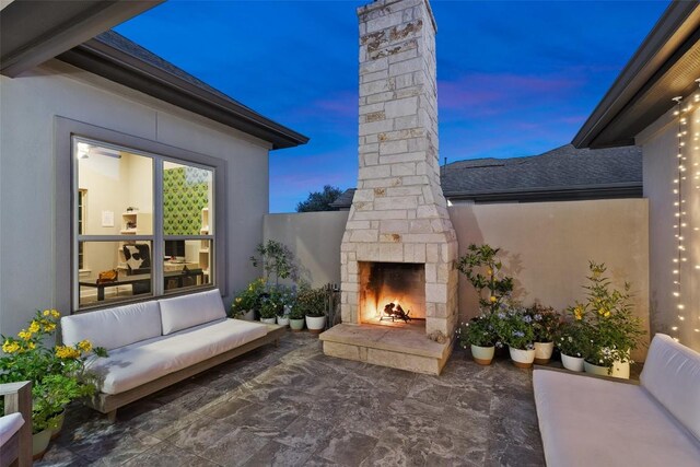 131 Katie Dr, Austin, TX 78737 - patio terrace at dusk with a patio area and an outdoor living space with a fireplace