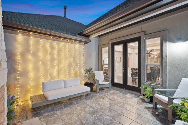 131 Katie Dr, Austin, TX 78737 - patio terrace at dusk with french doors, a patio area, and an outdoor hangout area