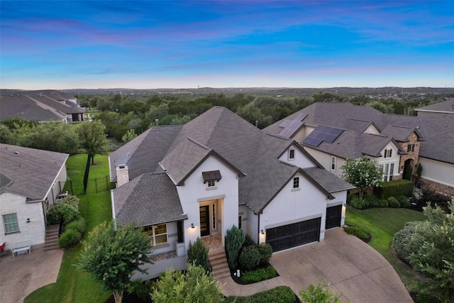 131 Katie Dr, Austin, TX 78737 - view of front facade with roof with shingles, stucco siding, driveway, an attached garage, and a residential view