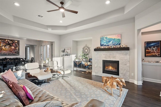 131 Katie Dr, Austin, TX 78737 - living area featuring a raised ceiling, ceiling fan, wood finished floors, recessed lighting, and a glass covered fireplace