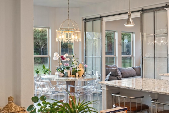 131 Katie Dr, Austin, TX 78737 - dining area featuring a chandelier, a barn door, and healthy amount of natural light