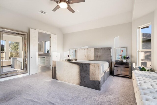 131 Katie Dr, Austin, TX 78737 - bedroom featuring light carpet, multiple windows, vaulted ceiling, and ensuite bathroom