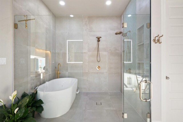 131 Katie Dr, Austin, TX 78737 - bathroom with tile walls, a stall shower, tile patterned floors, recessed lighting, and a freestanding bath