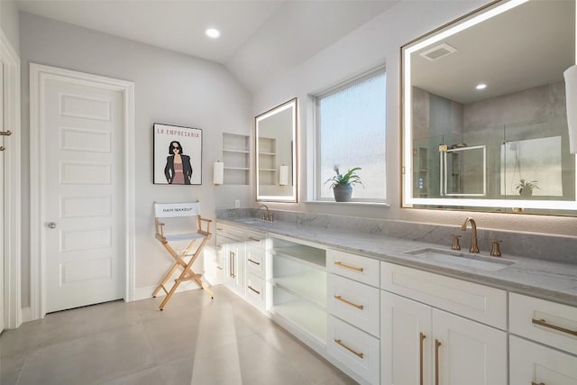 131 Katie Dr, Austin, TX 78737 - bathroom featuring a shower stall, double vanity, vaulted ceiling, and recessed lighting