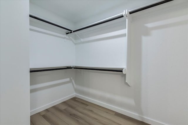11202 Alhambra Dr, Austin, TX 78759 - walk in closet featuring wood finished floors