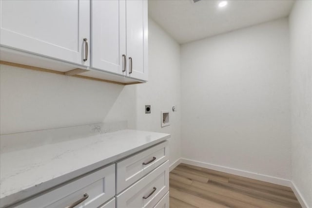 11202 Alhambra Dr, Austin, TX 78759 - laundry room featuring hookup for an electric dryer, light wood finished floors, hookup for a washing machine, and cabinet space