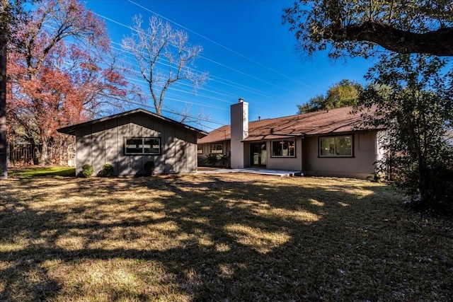 11202 Alhambra Dr, Austin, TX 78759 - rear view of house with a chimney, a lawn, and a patio