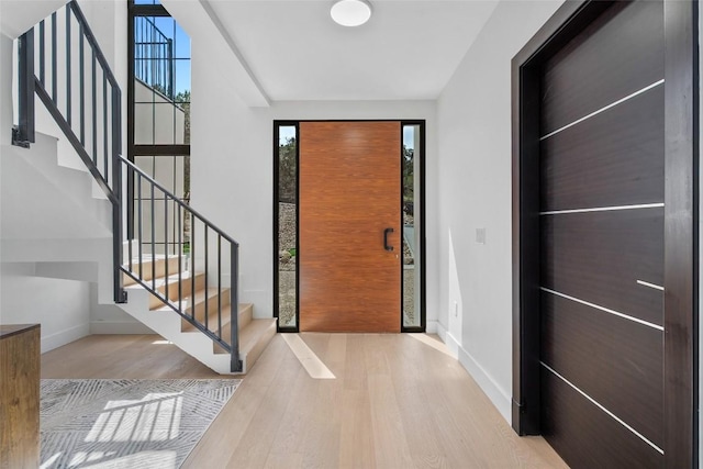 3206 Marshall Ave, Lago Vista, TX 78645 - entrance foyer featuring wood finished floors, plenty of natural light, and stairway
