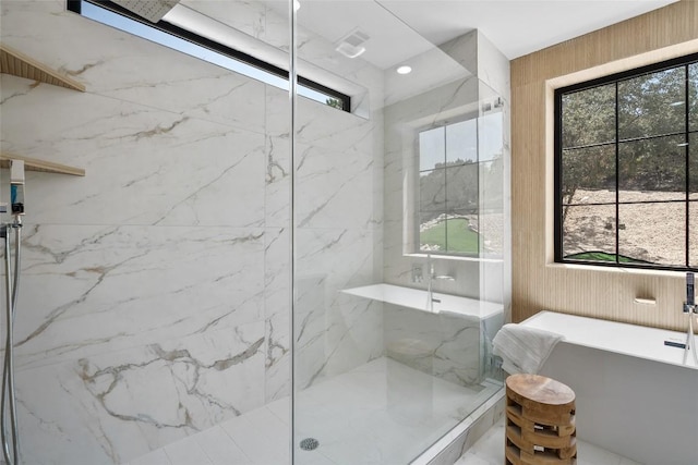 3206 Marshall Ave, Lago Vista, TX 78645 - full bath featuring a marble finish shower, a soaking tub, plenty of natural light, and wooden walls