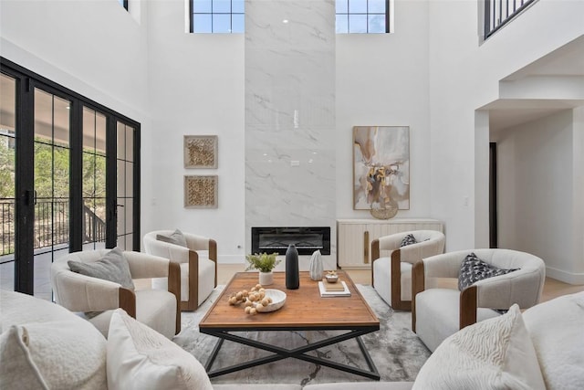 3206 Marshall Ave, Lago Vista, TX 78645 - living room featuring a high ceiling, plenty of natural light, a premium fireplace, and wood finished floors