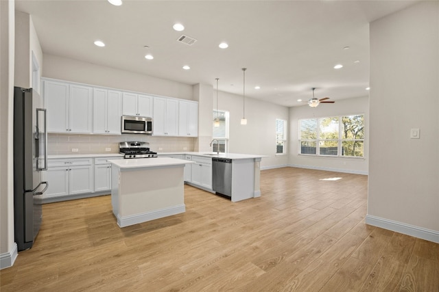 600 C-Bar Ranch Trl Unit 108, Cedar Park, TX 78613 - kitchen featuring appliances with stainless steel finishes, open floor plan, recessed lighting, backsplash, and white cabinetry