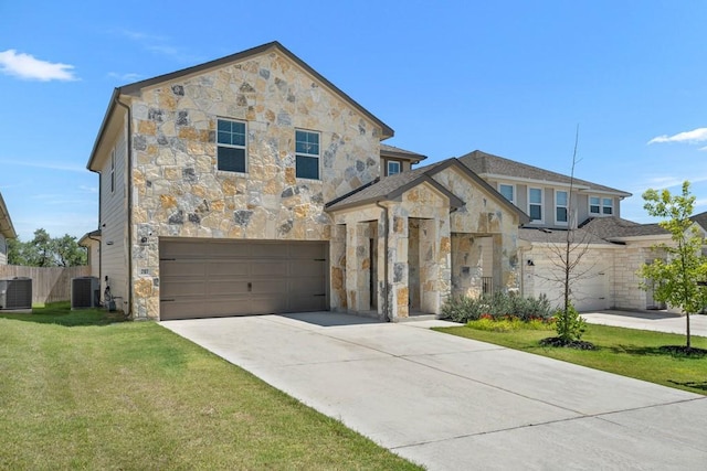 207 El Capitan Loop, Dripping Springs, TX 78620 - view of front of property with stone siding, driveway, and a garage