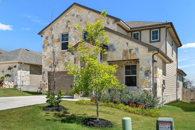 207 El Capitan Loop, Dripping Springs, TX 78620 - view of front of house featuring stone siding, a front lawn, concrete driveway, and a garage