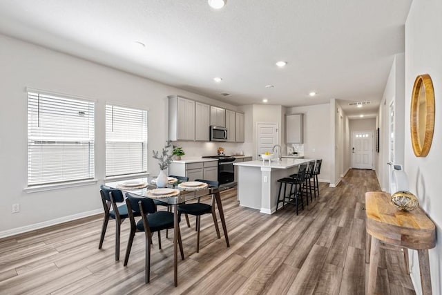 207 El Capitan Loop, Dripping Springs, TX 78620 - dining room with light wood-style flooring and recessed lighting