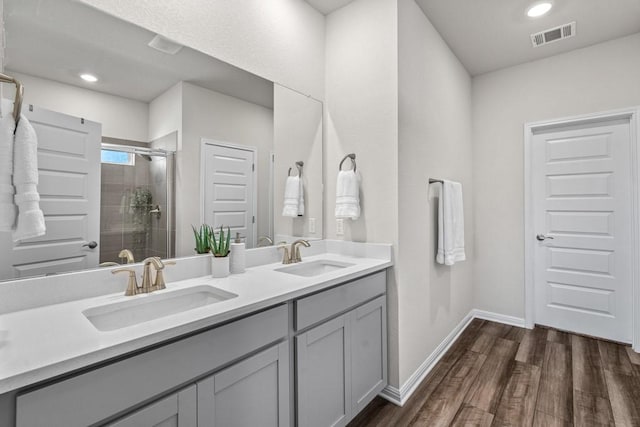 207 El Capitan Loop, Dripping Springs, TX 78620 - full bath featuring double vanity, a stall shower, wood finished floors, and recessed lighting