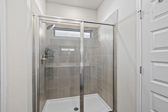 207 El Capitan Loop, Dripping Springs, TX 78620 - bathroom featuring a shower stall and a textured wall