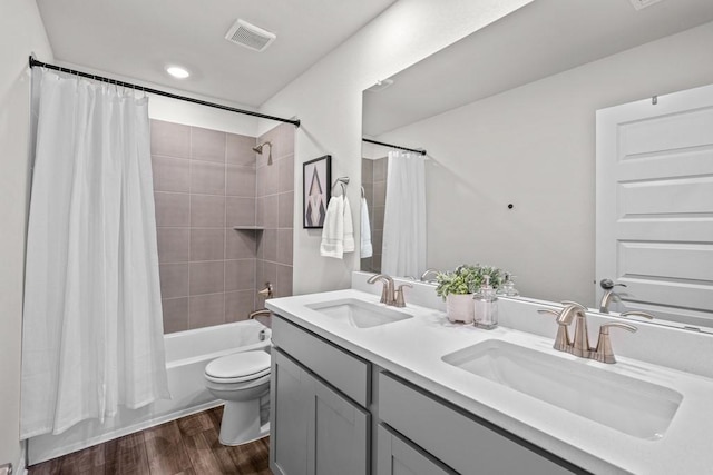 207 El Capitan Loop, Dripping Springs, TX 78620 - bathroom featuring wood finished floors, double vanity, and shower / bath combo